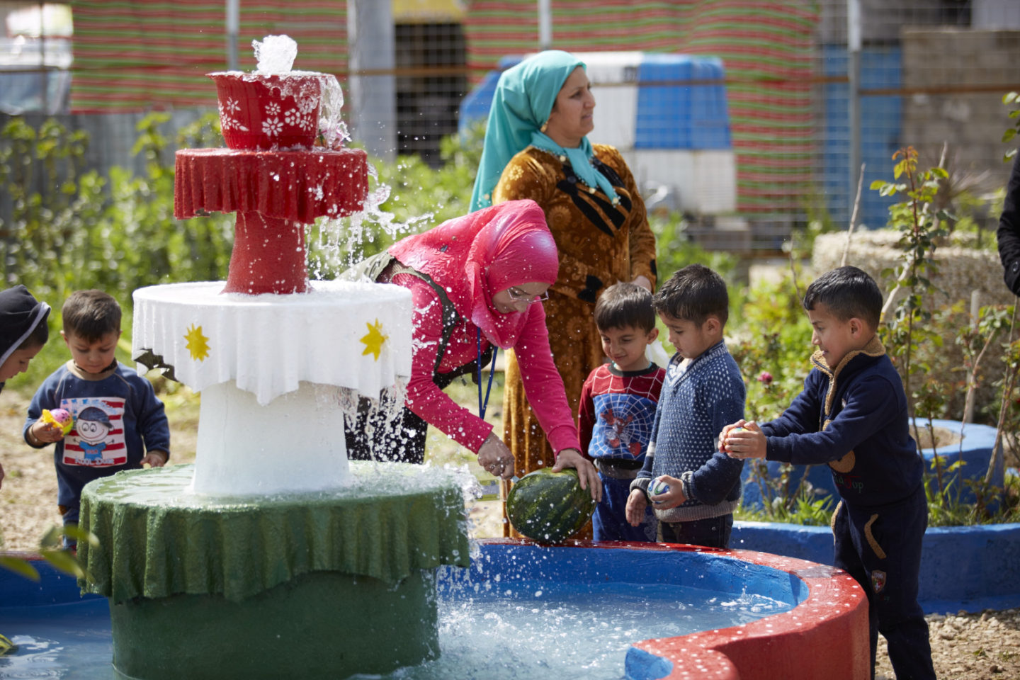 Donna con bambini vicino alla fontana